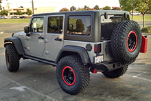 Jeep with black rims and red hoops